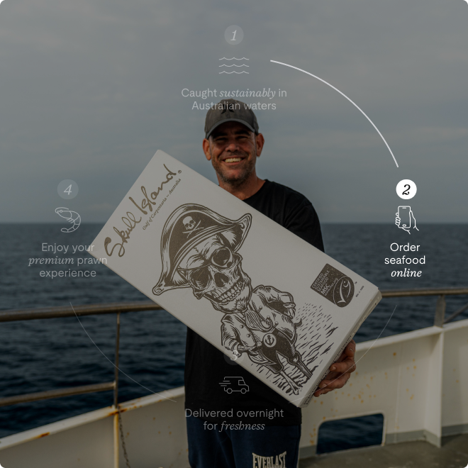 Man holding up 9kg box of prawns at sea